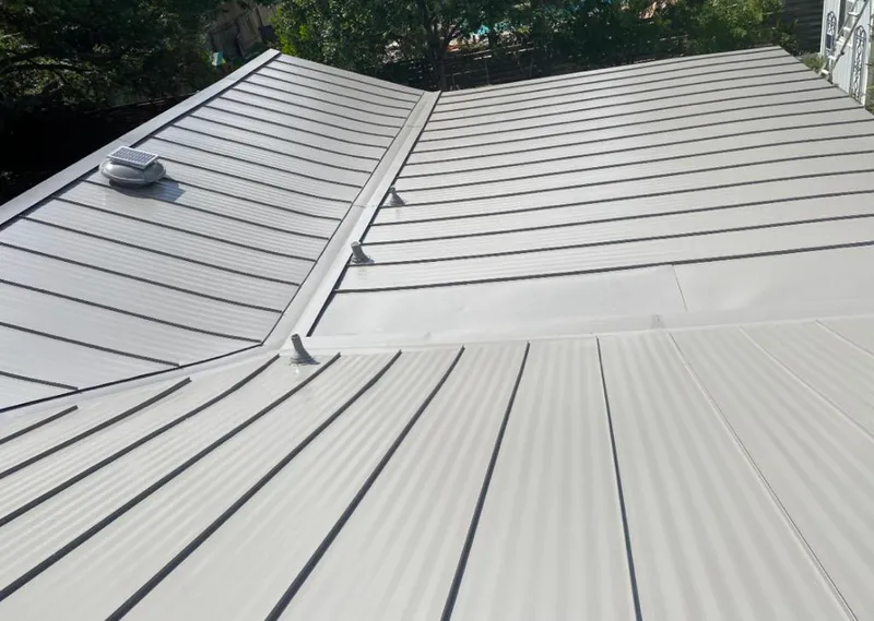 Solar attic fan installed on a metal roof for Roof Ventilation in Newstead